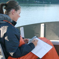 Researcher taking notes during a whale survey